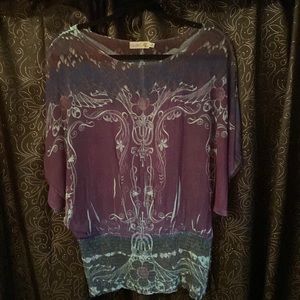Unity World Wear semi-sheer, silky blouse with gathered, elastic hip/waist line.